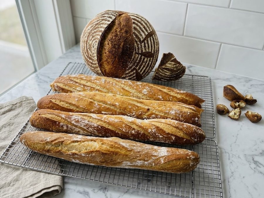 A spread of fresh sourdough loaves and baguettes